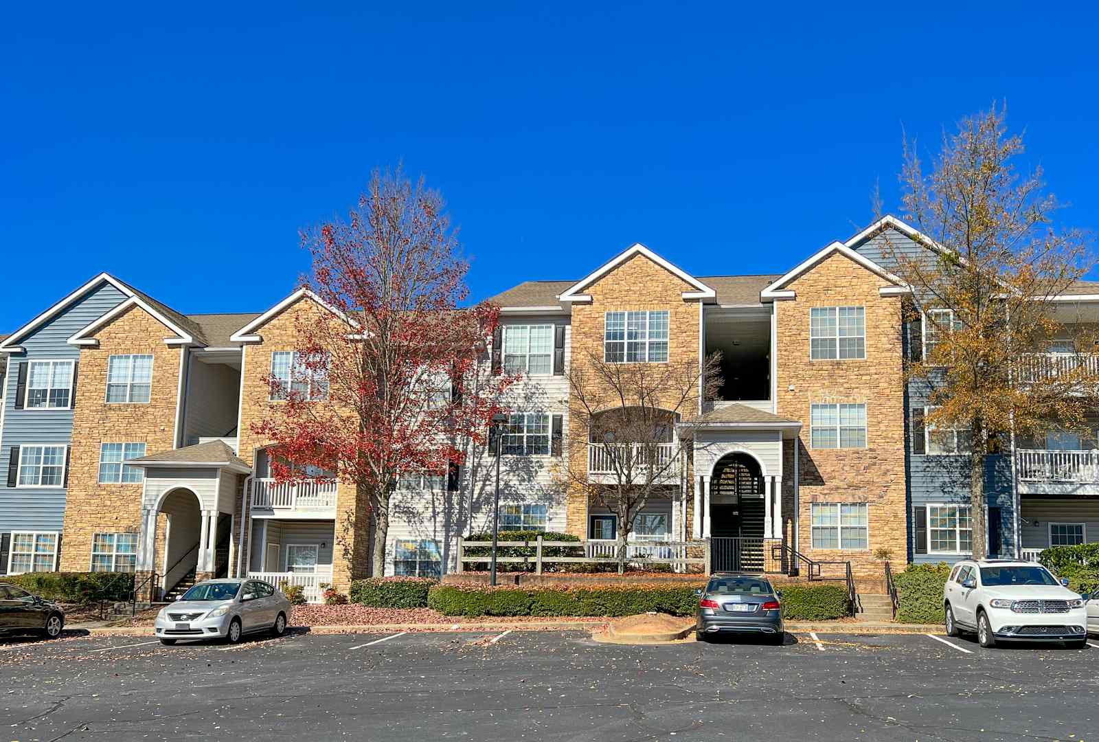 exterior view of Halston Riverside apartment building from parking lot