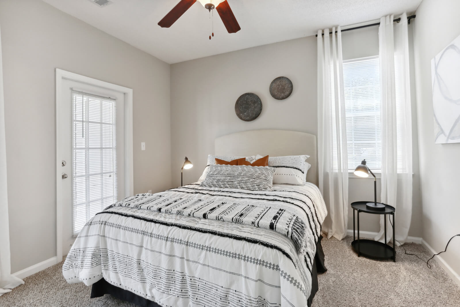 model bedroom with carpet and ceiling fan