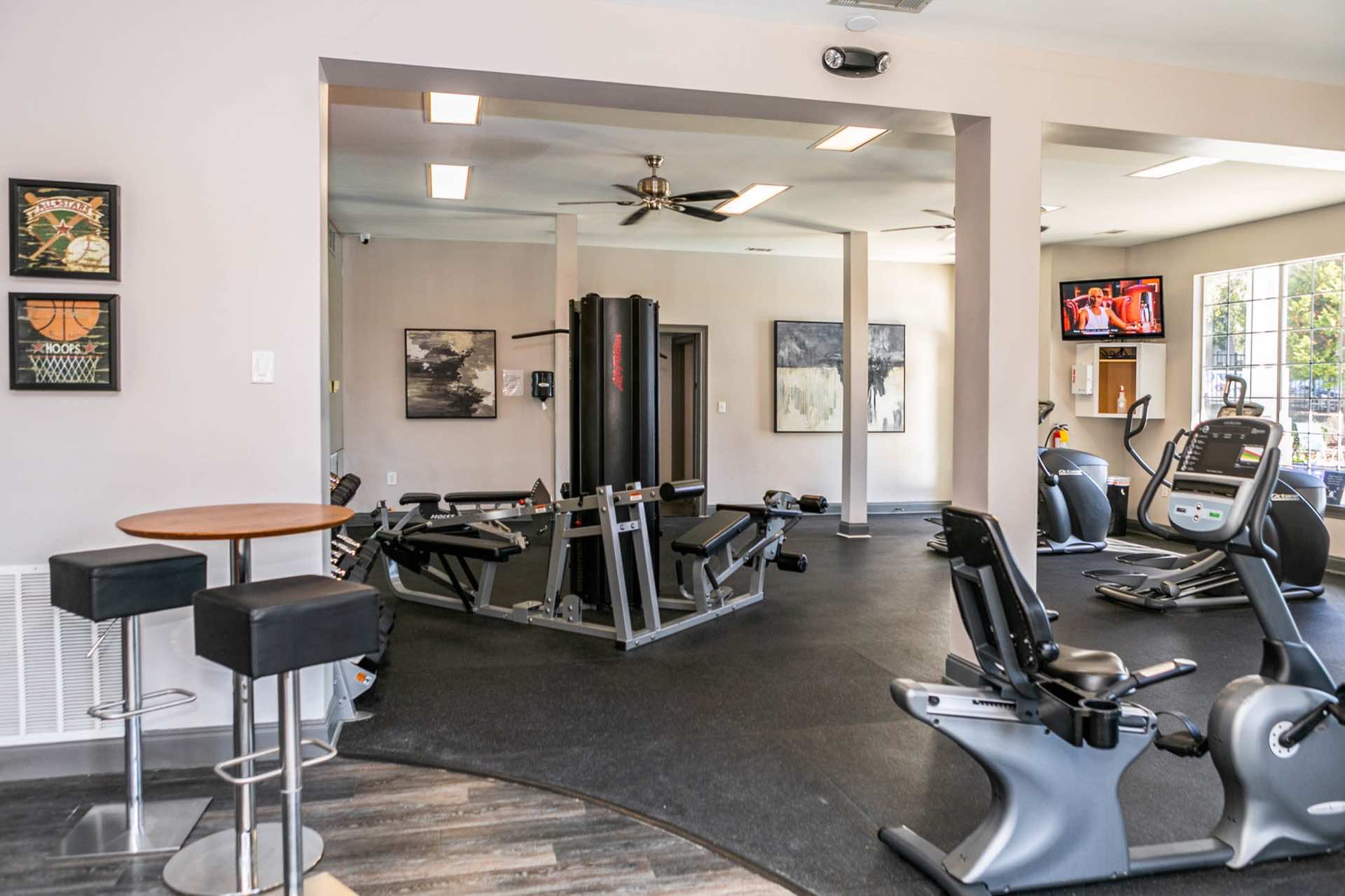 fitness room with modern equipment and ceiling fans