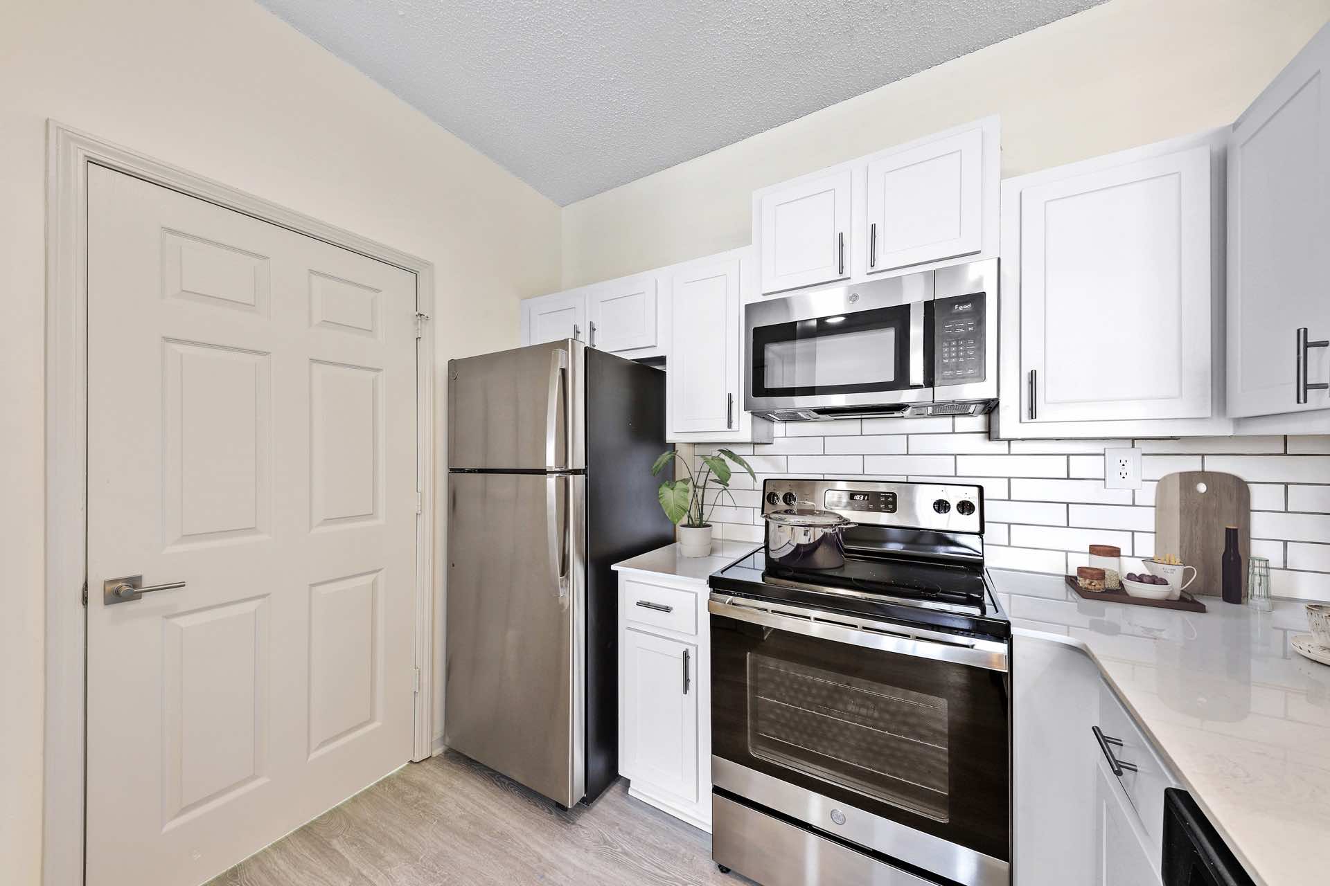 kitchen with white shaker cabinets and tile backsplash